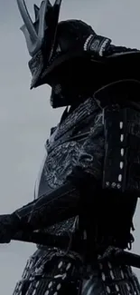 Silhouetted samurai warrior in black armor with sword.