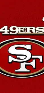 San Francisco 49ers logo on red wallpaper.