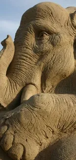 Intricate sand sculpture of an elephant for mobile wallpaper.