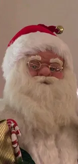 Santa Claus with gifts and candy cane in festive setup.