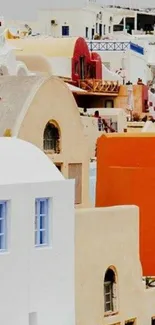 Santorini's iconic white and colorful buildings under a clear sky.