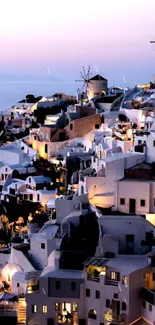 Santorini at dusk with windmills and white architecture under a pastel sky.