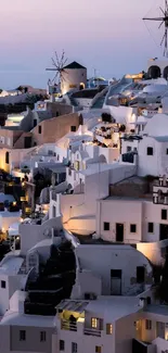 Santorini's evening glow with windmills against the twilight sky.