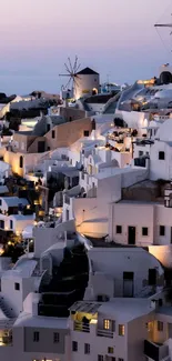 Santorini at night with illuminated buildings and classic architecture.