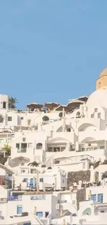 Scenic Santorini view with white buildings and blue sky.