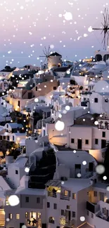 Santorini sunset with white windmills and architecture illuminated.