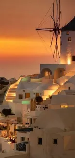 Santorini buildings and windmill at sunset.