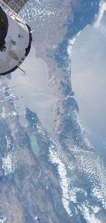 Satellite view of Earth showing land, sea, and clouds from space perspective.