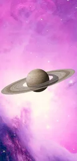 Saturn with rings in a vibrant pink galaxy wallpaper.