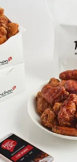 Plate of crispy Bonchon chicken with mobile branding.