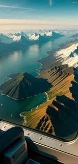 Aerial view of mountains from an airplane window, showcasing snow and green landscapes.