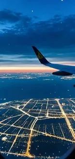 Aerial view of city at night from airplane window.
