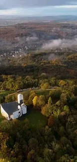 Aerial view of a lone house amidst rolling autumn hills.