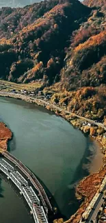 A scenic autumn river bend with colorful foliage and mountains.