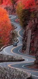 Winding road through vibrant red autumn foliage.