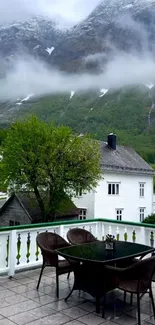 Mountains with mist viewed from a balcony.