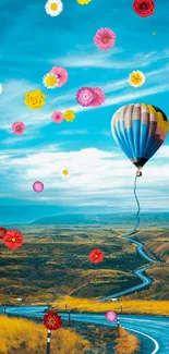 Hot air balloon over scenic road landscape with blue sky.