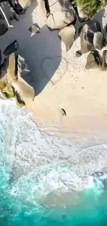 Aerial view of a beach with turquoise waves and rocky shoreline.