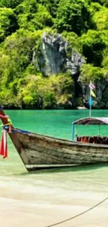 Traditional boat on a tropical beach with green cliffs and turquoise water.