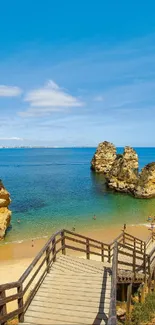 Scenic view of beach, ocean, and cliffs under a blue sky.