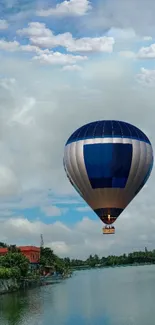 Hot air balloon floating over serene lake.