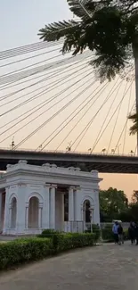 Elegant view of bridge spanning over historic monument at sunset.