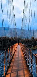 Scenic bridge over water with blue sky and lush greenery.