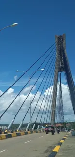 Cable-stayed bridge under vibrant blue sky with clouds.