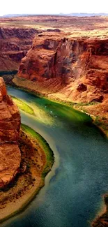 A stunning view of a winding river through a majestic canyon with brown cliffs.