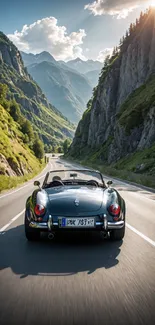 Classic convertible driving through scenic mountain pass.