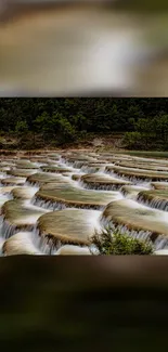 Scenic cascade waterfall with lush greenery as a mobile wallpaper.