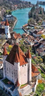 Aerial view of a scenic castle by a turquoise lake.