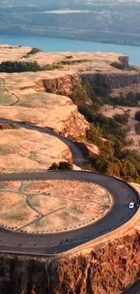 Aerial view of a winding road on stunning cliffs.