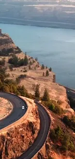 Aerial view of cliffside road with river.