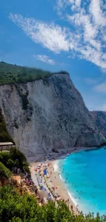 Stunning seaside cliff with turquoise waters and clear blue sky.