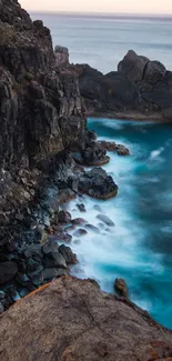 Mobile wallpaper of a coastal cliff with blue ocean waves.