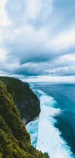 Breathtaking view of a coastal cliff with lush greenery and a vast ocean under a cloudy sky.