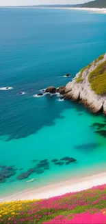 Scenic turquoise coastal cliff with vibrant flowers.