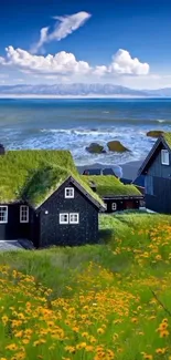 Scenic view of coastal cottages by the ocean with flowers and a blue sky.