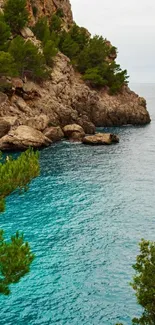 Scenic coastal view with cliffs and cyan blue sea under cloudy skies.