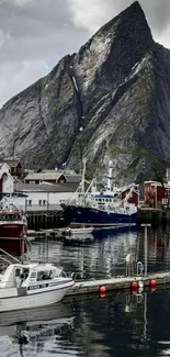 Mountain and harbor with boats in a serene coastal setting.