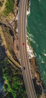 Aerial view of a scenic coastal road with ocean and landscape.