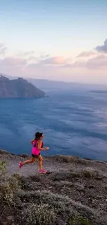 Two runners on a coastal trail with ocean and mountain view.