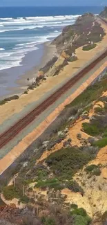 Coastal train hugging the shoreline with ocean waves.