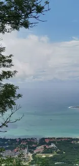 Scenic view of ocean and coast framed by greenery.