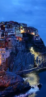 Scenic coastal village illuminated under a vibrant blue evening sky.