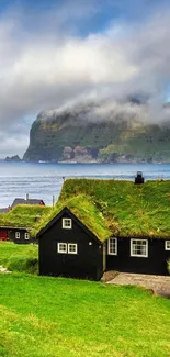 Coastal village with grass-roofed houses and dramatic cliffs.