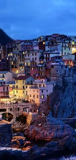 Colorful coastal village at twilight with vibrant houses and seaside cliff.