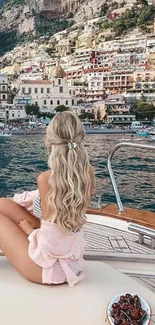 Woman relaxing on boat with a scenic coastal view.