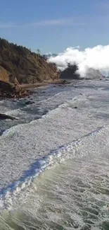 Scenic view of coastal waves against rocky cliffs under a bright sky.